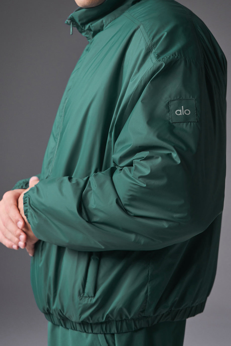Front view of lightweight nylon running jacket with half-zip for men and women