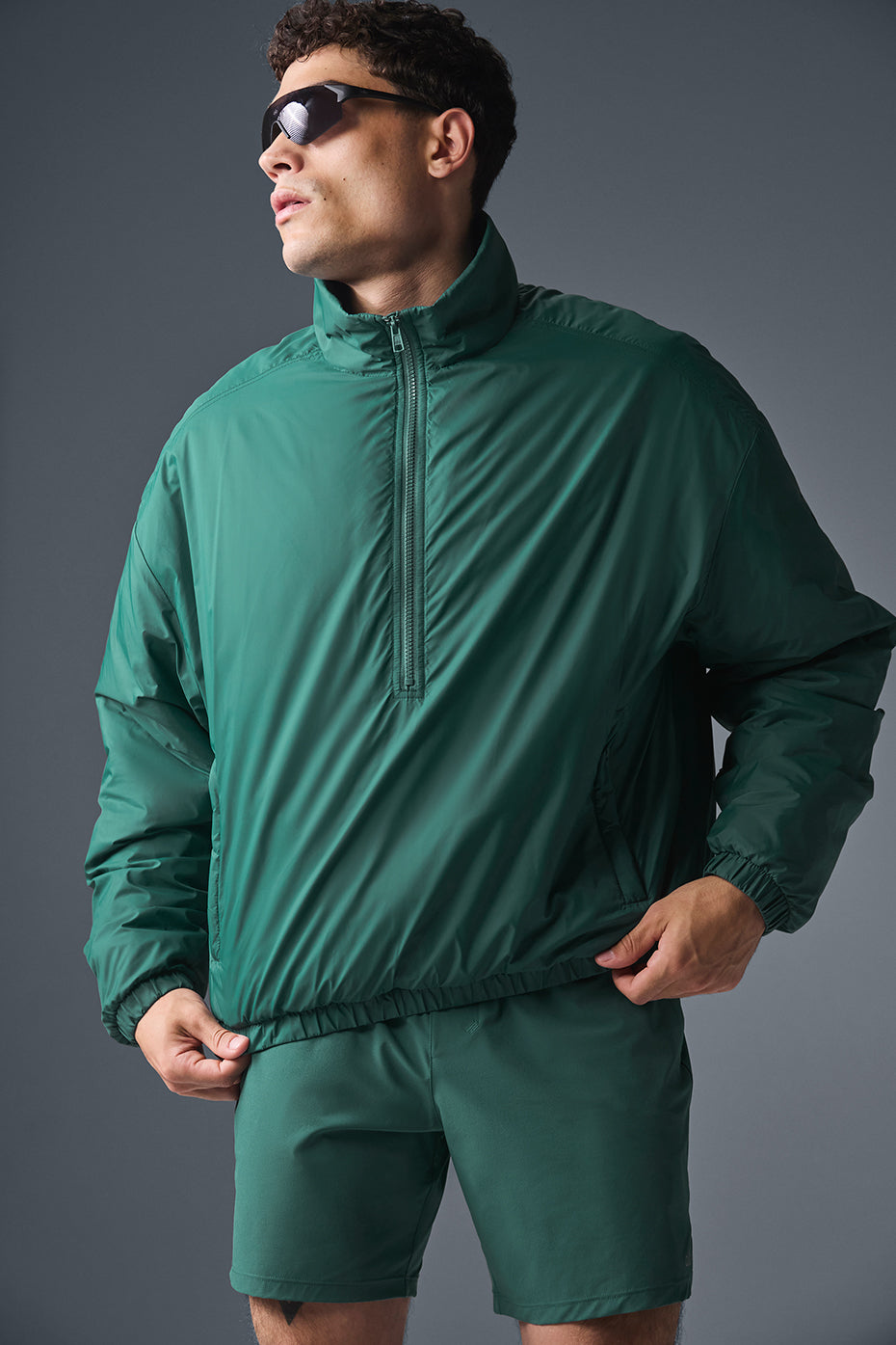 Side profile of the pullover jacket showing banded cuffs and hem in outdoor setting