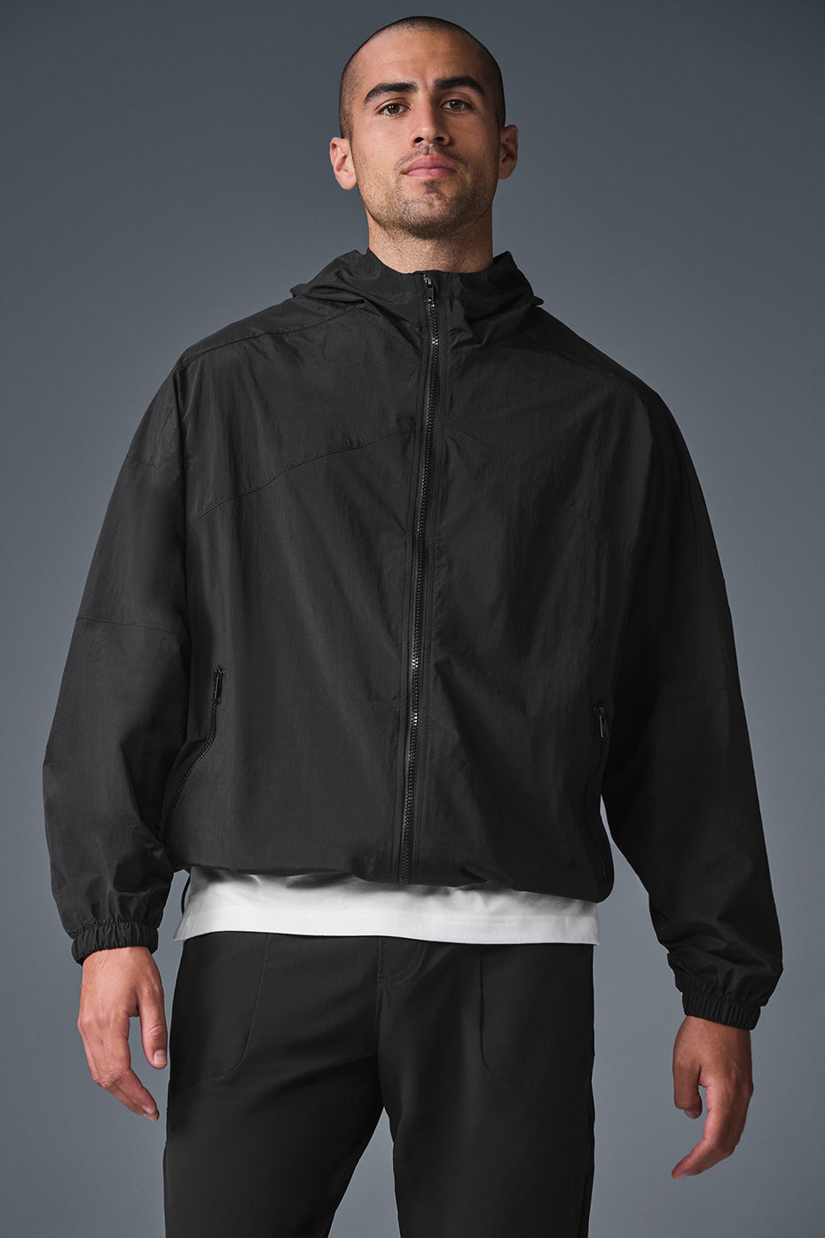 Front view of Vantage black nylon bomber track jacket in action.