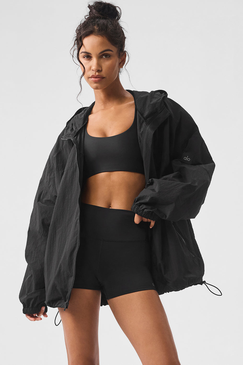 Black performance track jacket styled loosely for urban runs
