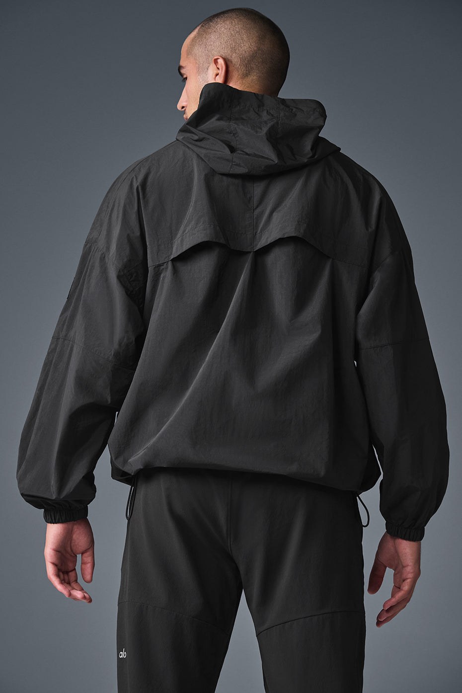 Side view showcasing the structured hood of the nylon jacket.