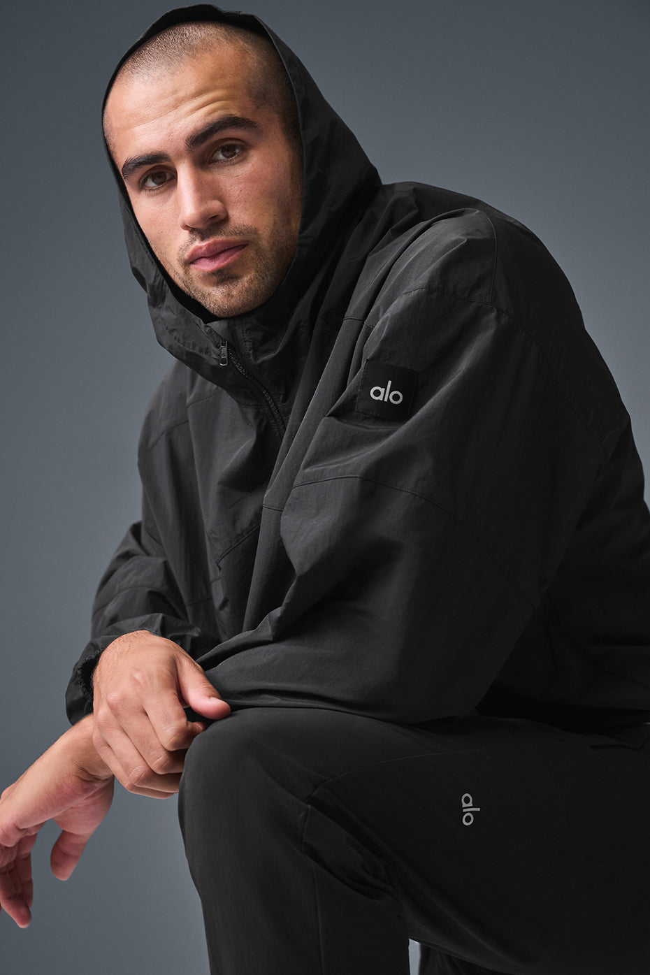 Back view highlighting the bungee hem of the track jacket.