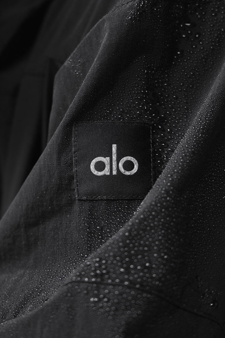 Front view of Vantage black nylon bomber track jacket in action.