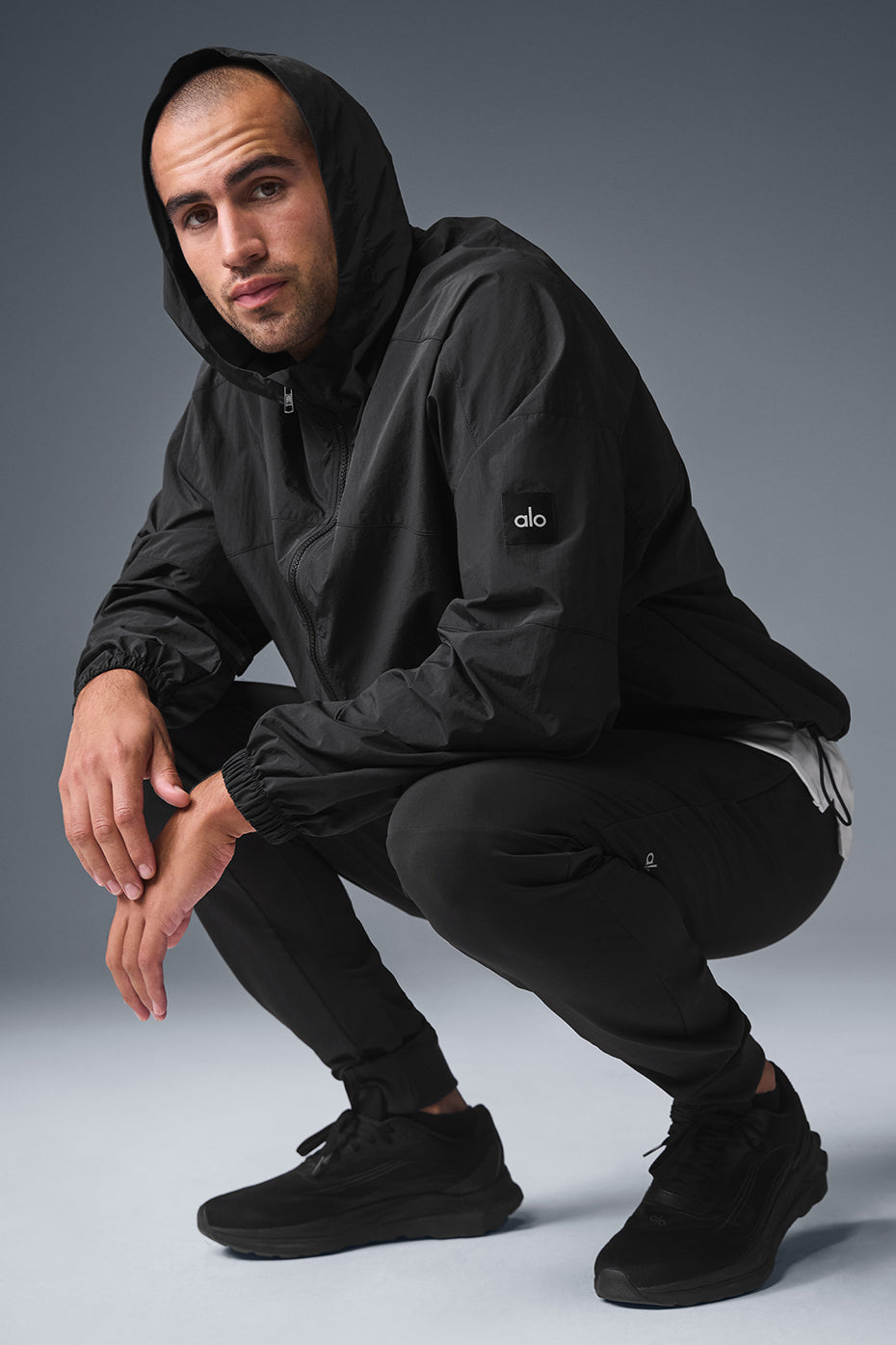 Side view showcasing the structured hood of the nylon jacket.