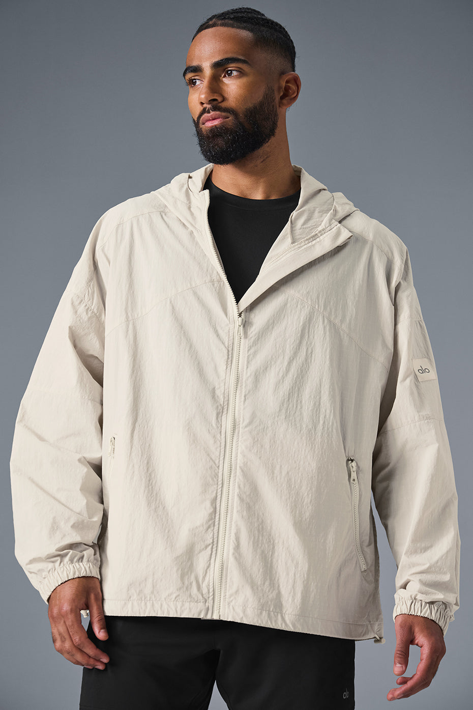 Close-up of the Vantage nylon ripstop track jacket's structured hood and full-zip front for outdoor running