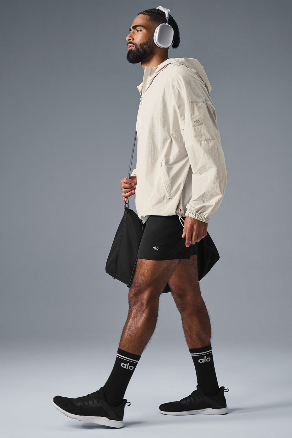 Close-up of the Vantage nylon ripstop track jackets structured hood and full-zip front for outdoor running