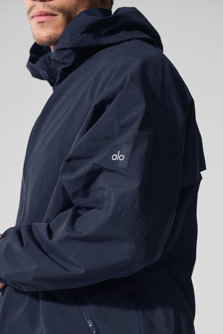 Back view highlighting the bungee hem and relaxed fit of the track jacket.