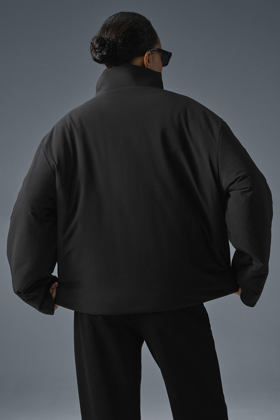 Close-up of woven detailing and leather accents on the jacket’s front pockets.
