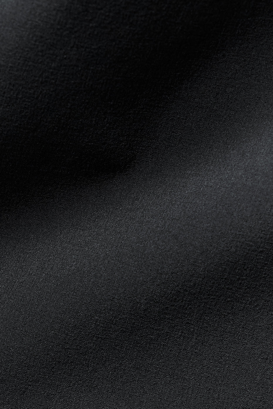 Close-up of woven detailing and leather accents on the jacket’s front pockets.