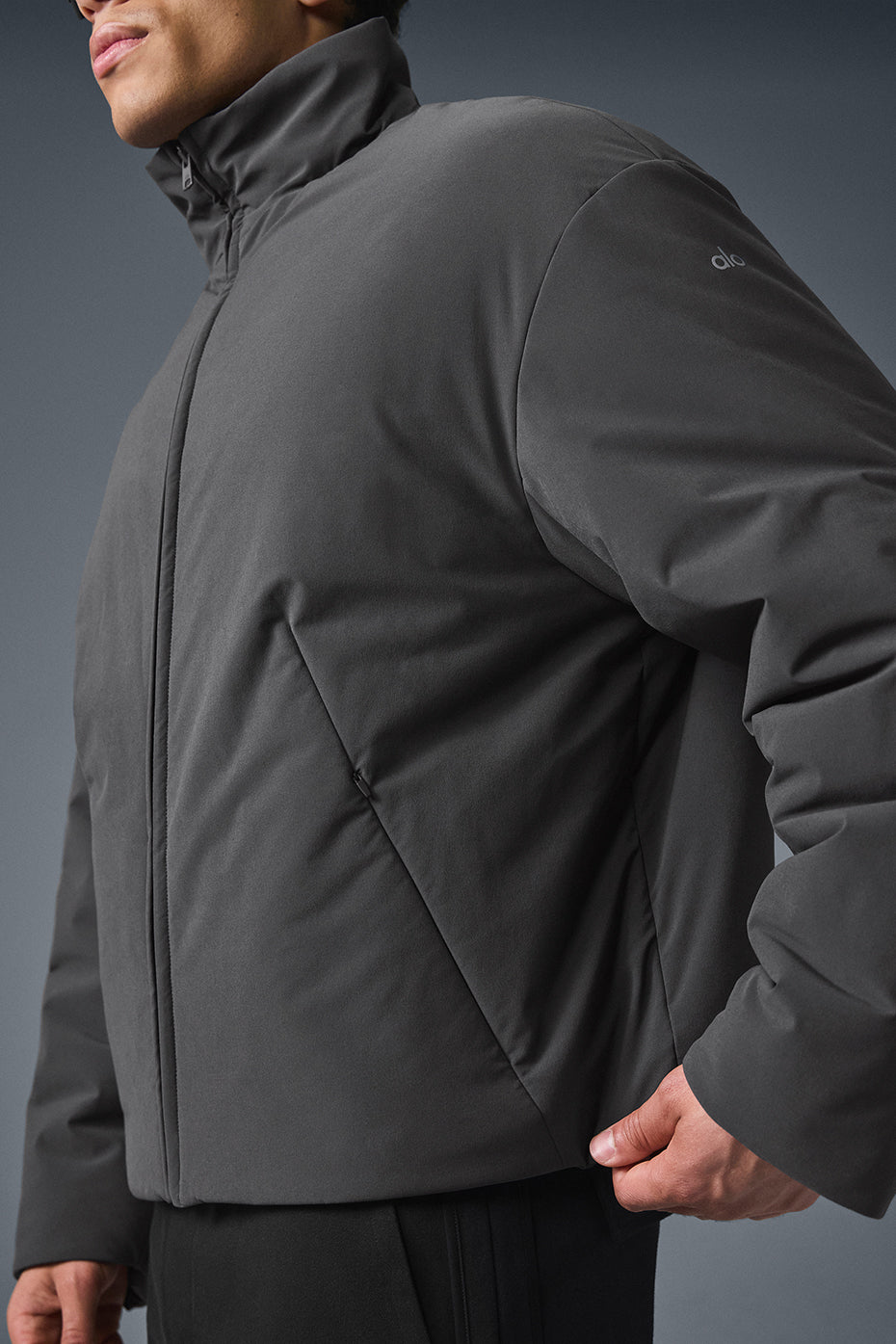 Styling the jacket unzipped over a hoodie for layered look
