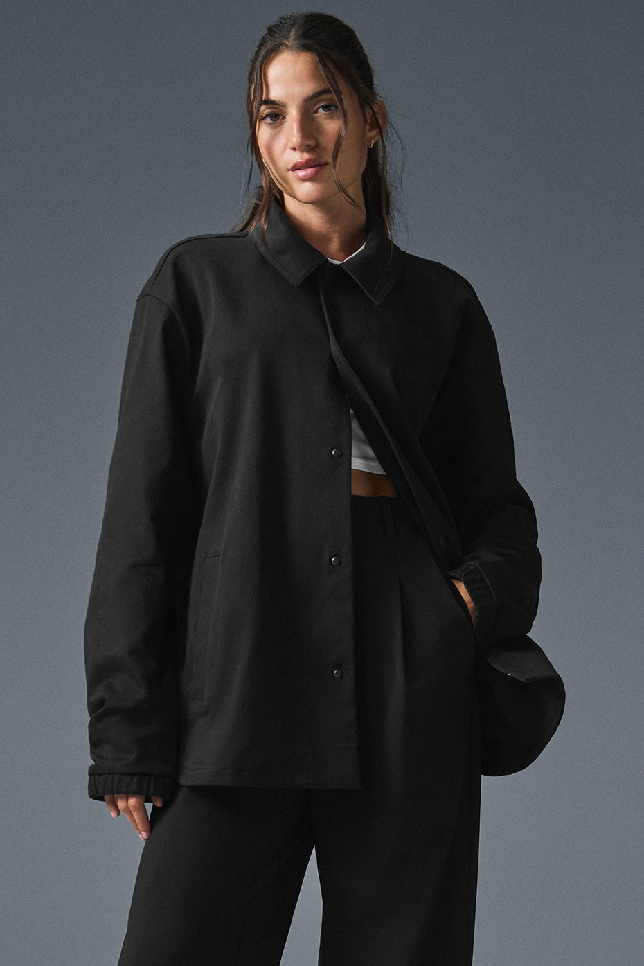 Front view of the black suede jacket with snap buttons and elastic cuffs