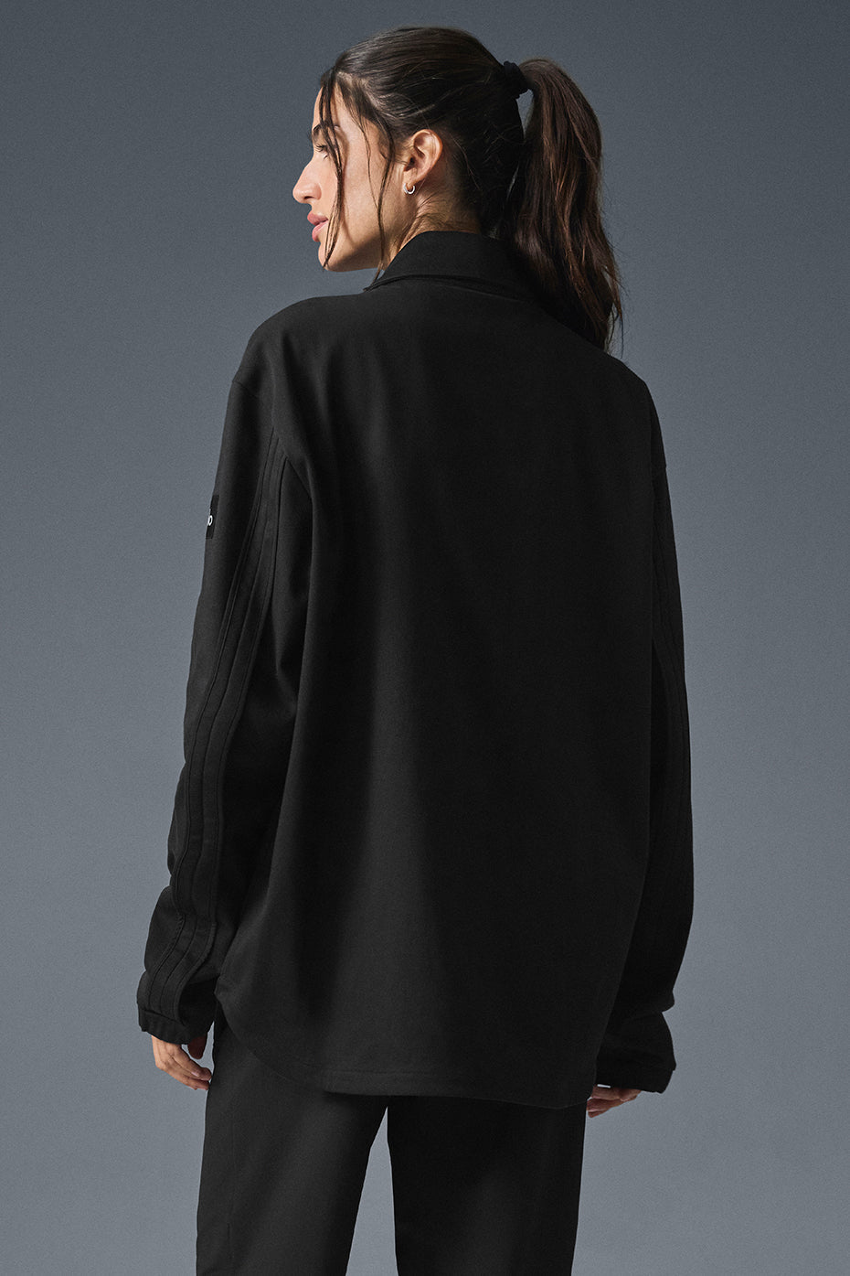Model wearing the black bomber jacket styled for casual outings