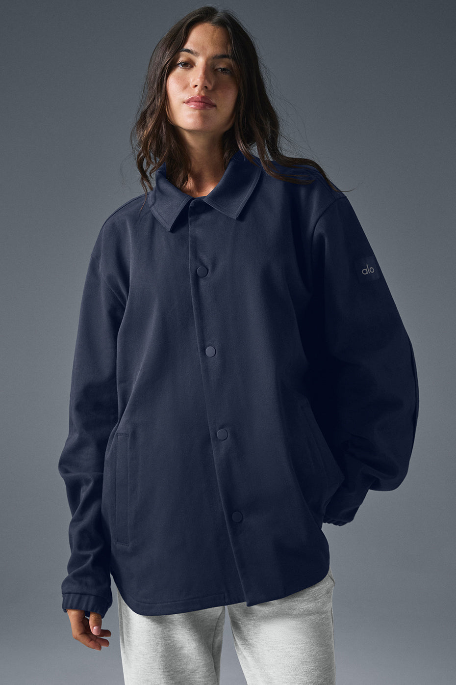 Front view of navy suede bomber jacket worn casually.