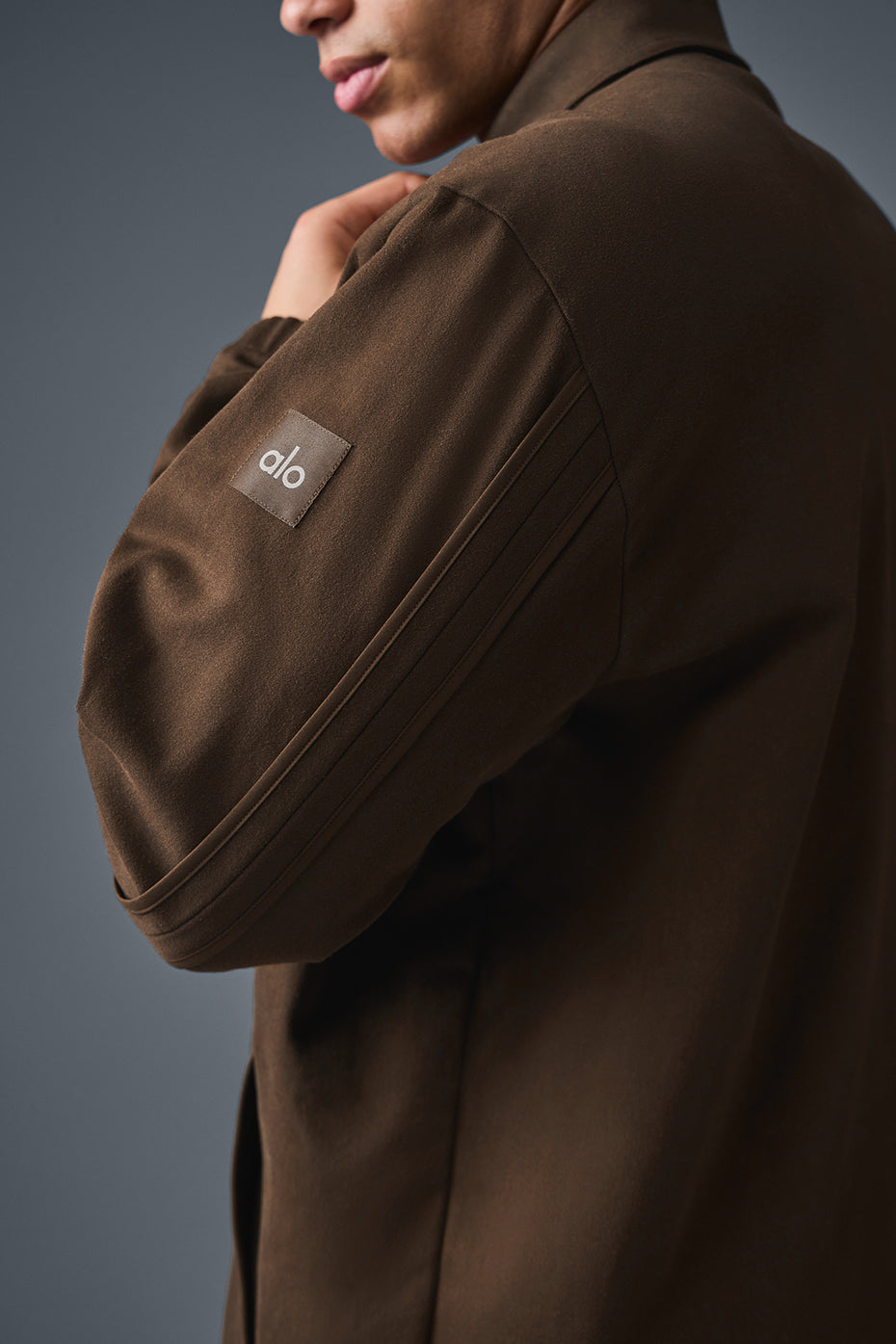 Model wearing the espresso suede jacket with joggers for a complete look.