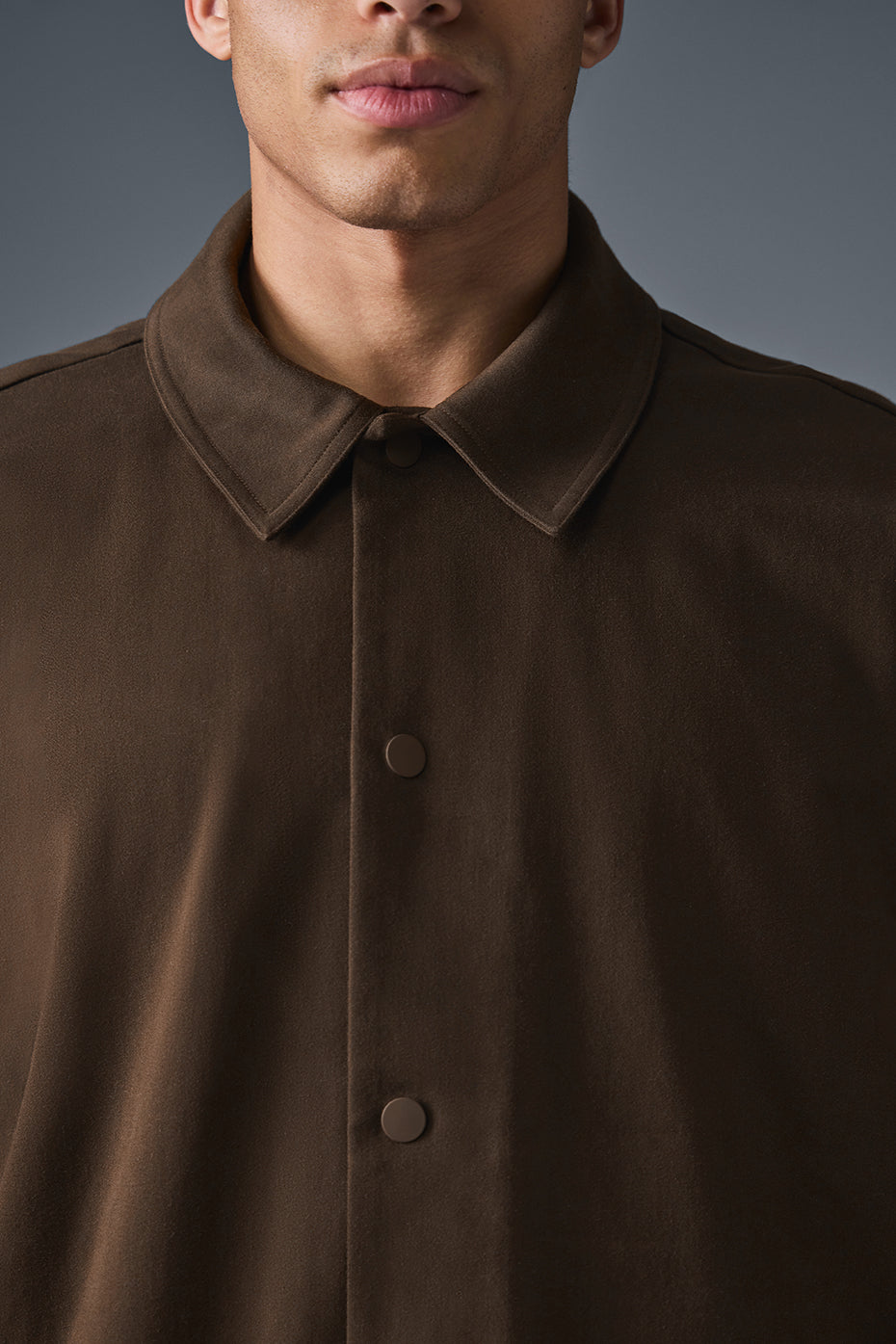 Front view of the espresso suede bomber jacket for men.