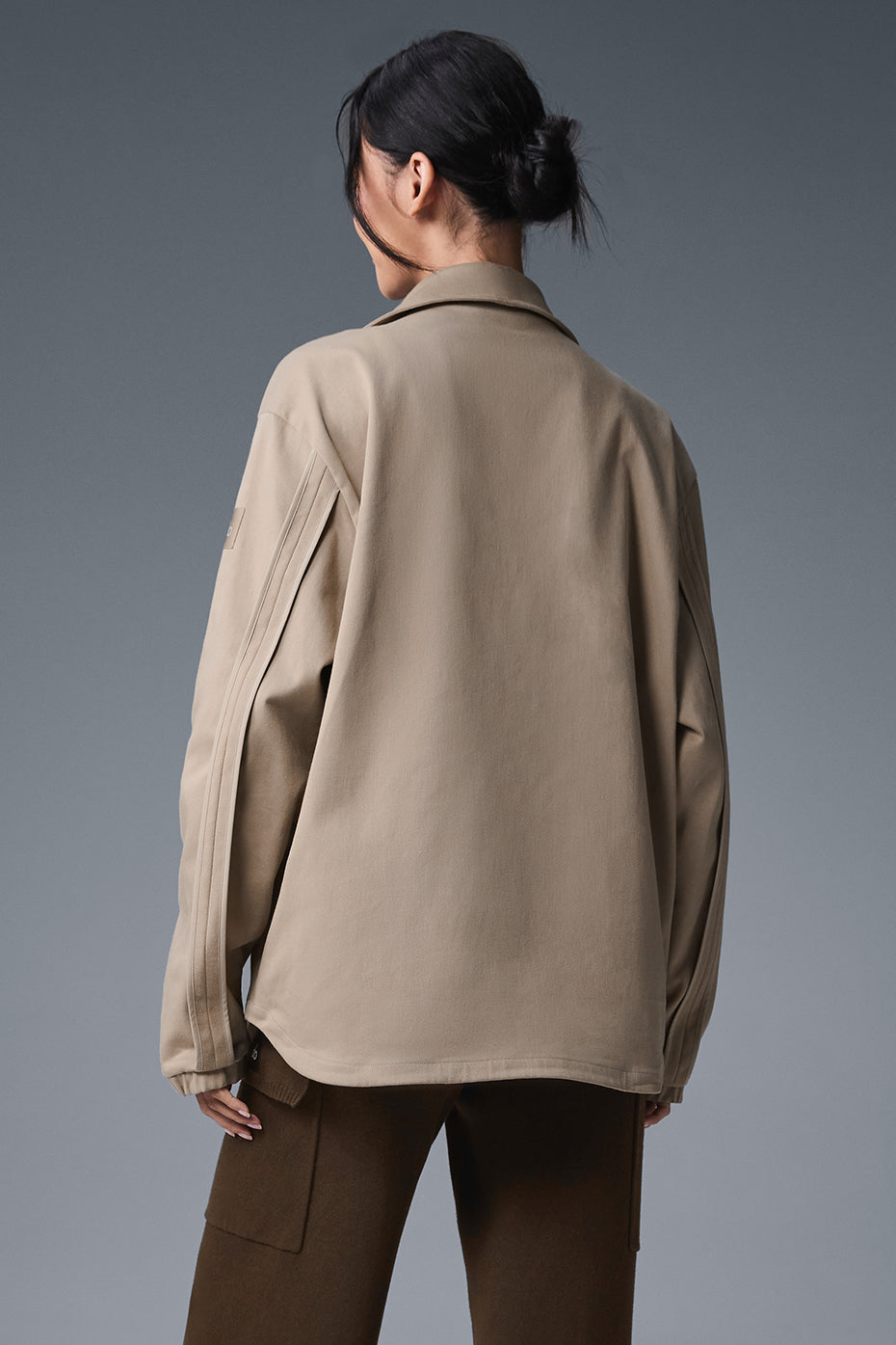 Model wearing the suede bomber jacket in a casual urban setting.