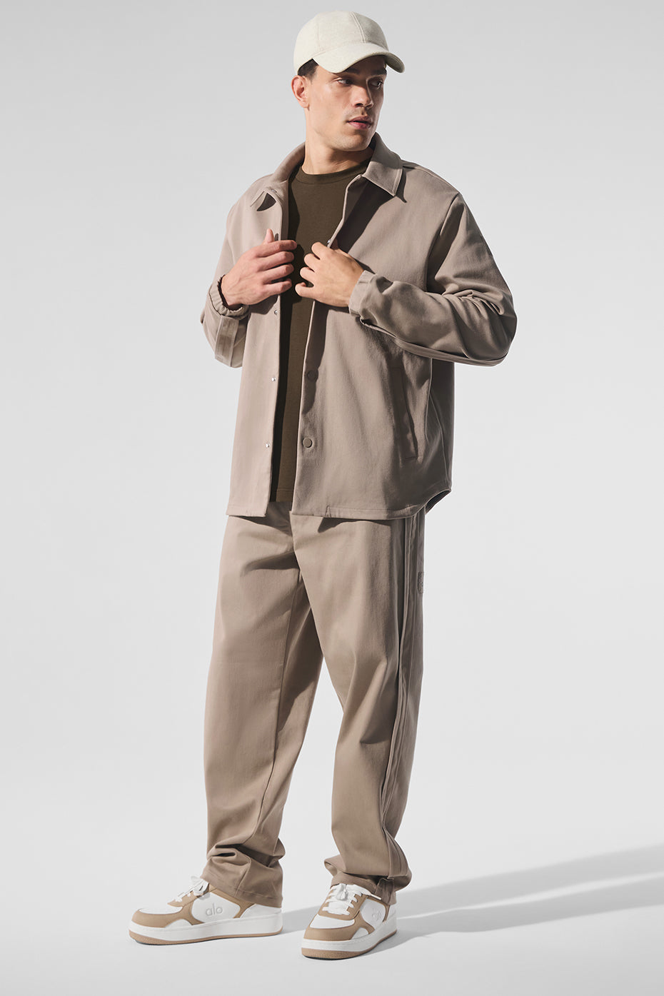 Front view of the gravel suede bomber jacket on model showing structured fit and snap buttons