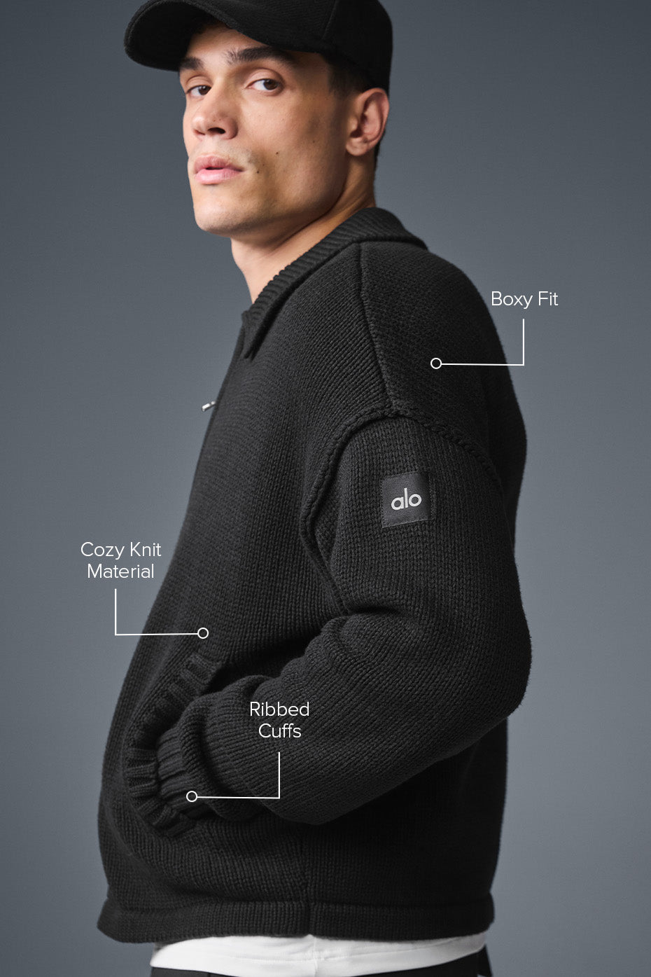 Model wearing black full zip sweater with side pockets, casual outfit