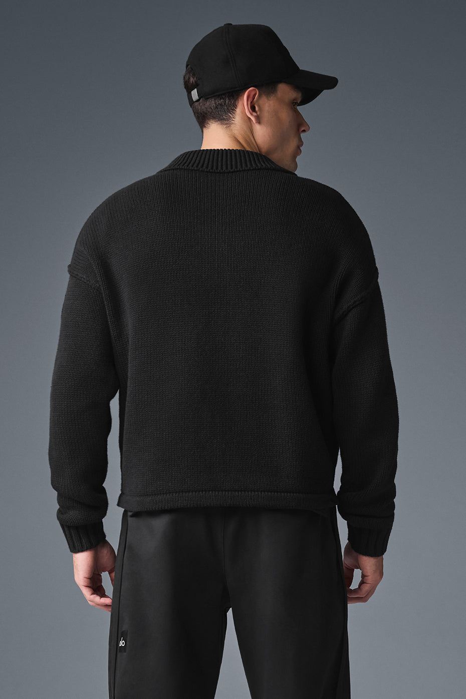 Full view of Heritage sweater styled with jeans and accessories