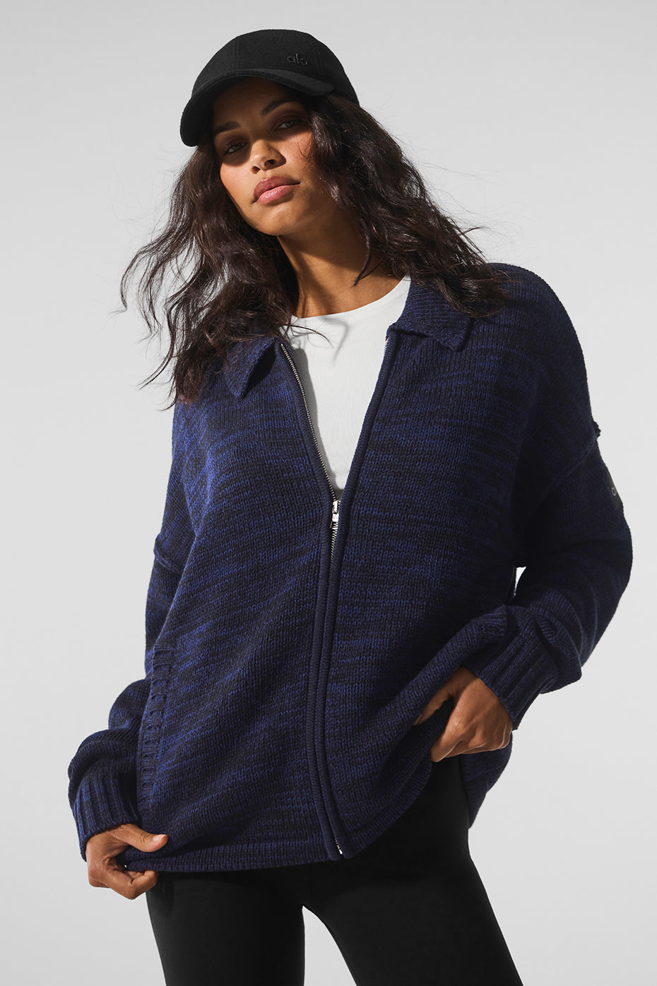 Front view of navy multi full zip sweater with sleek collar and side pockets