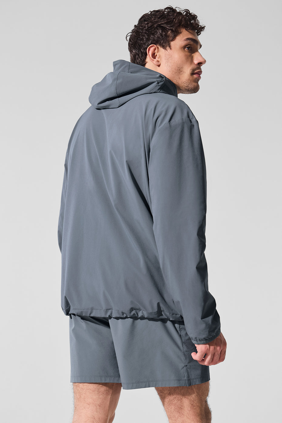 Casual outfit featuring the peak performance gym jacket in a park setting.
