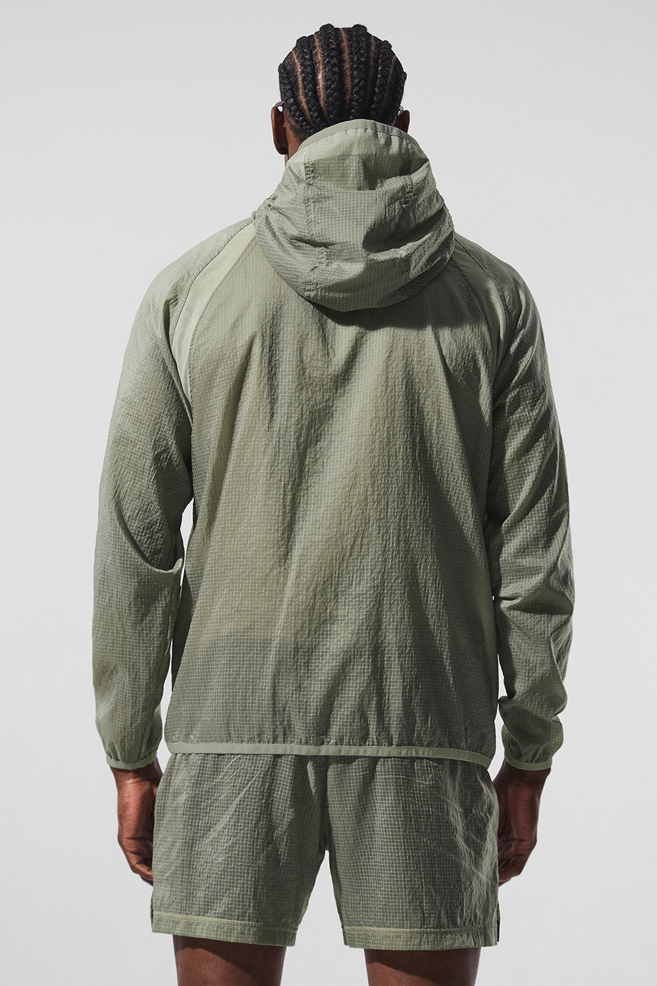 Back view of the lightweight down jacket, perfect for layering during workouts.