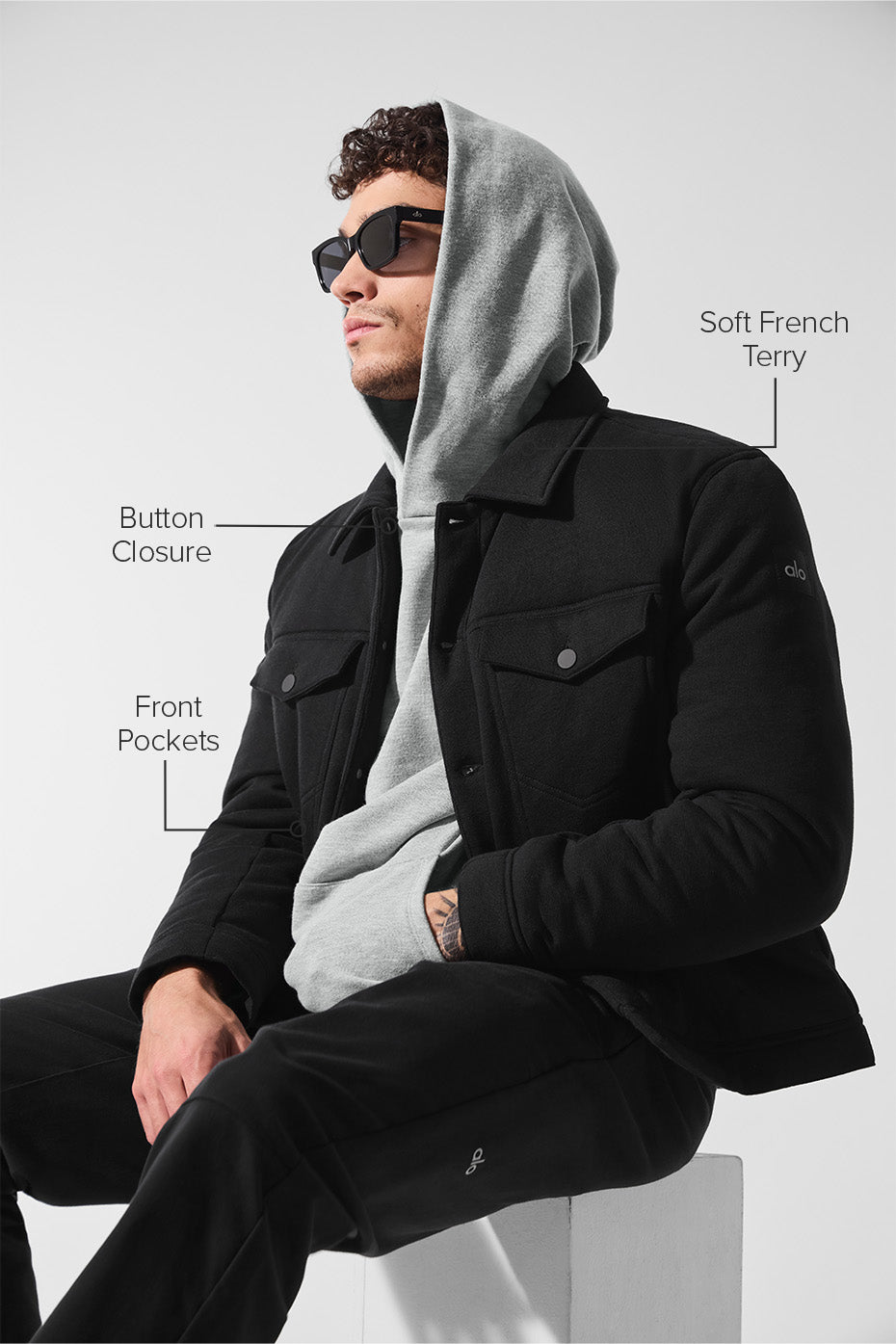 Side view of the black trucker jacket, highlighting the pockets and fit.