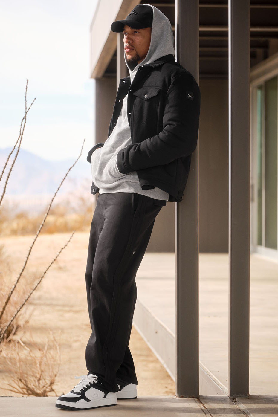 Model wearing the black bomber jacket, styled for a casual day out.