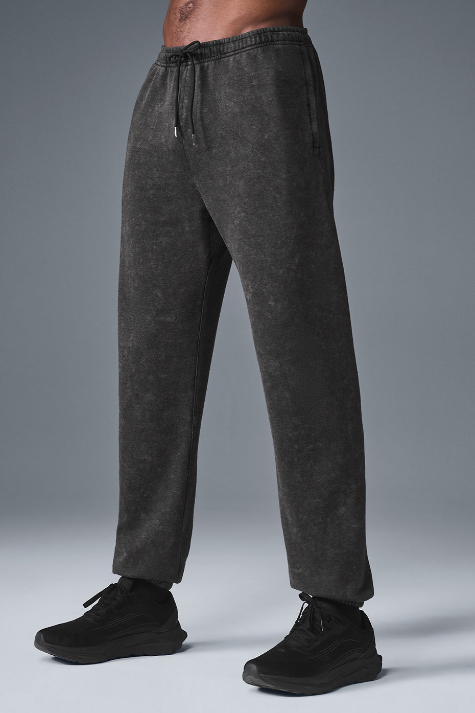 Lifestyle shot of black joggers mens edition worn in a California outdoor setting