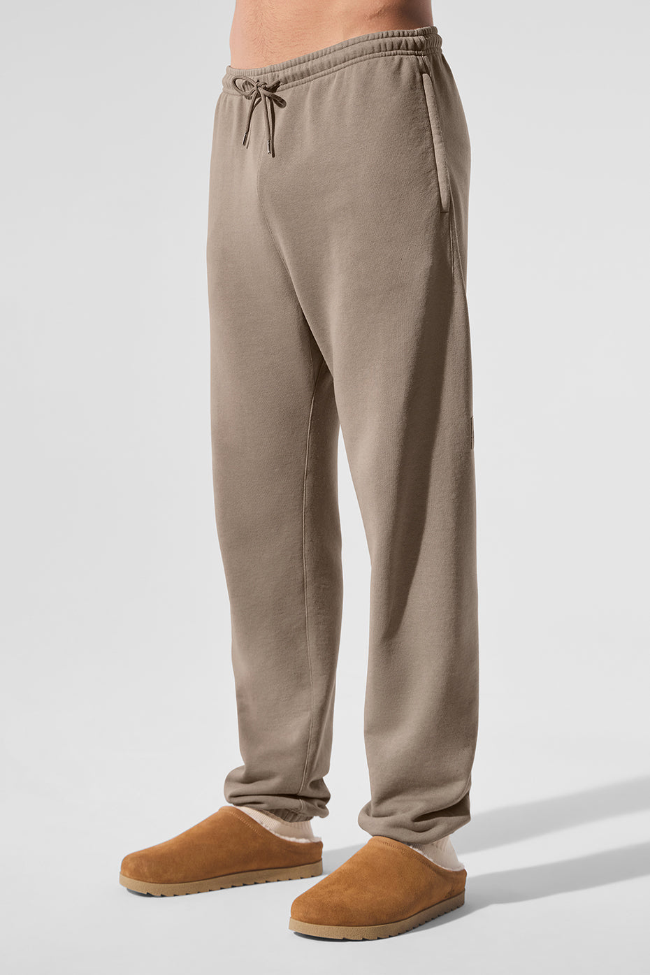 Detail shot of zippered pockets and cuffed hem on camo sweatpants