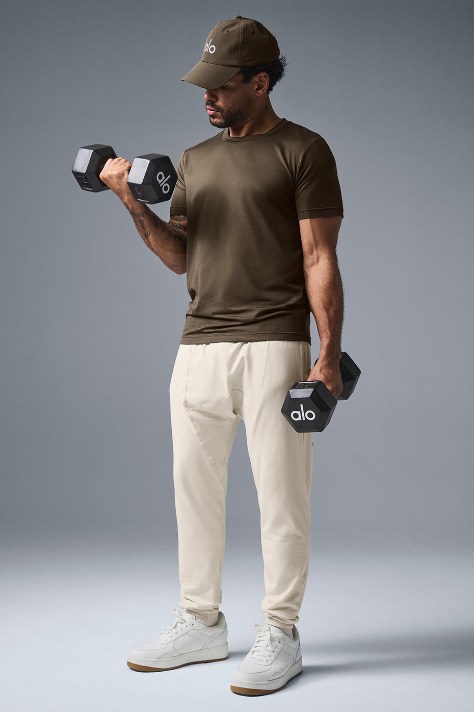 Front view of Urban Revive Yoga Pants for women, showcasing tapered design and zip pockets.