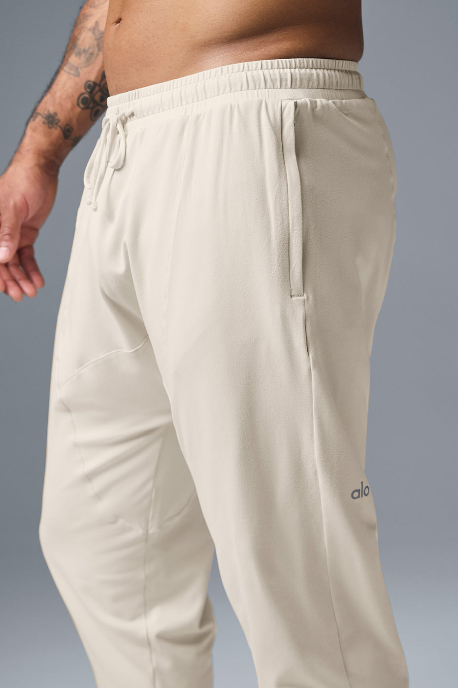 Front view of Urban Revive Yoga Pants for women, showcasing tapered design and zip pockets.
