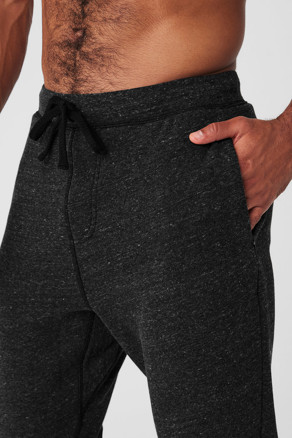 Front angle of mens workout pants with zip pockets and ribbed calves