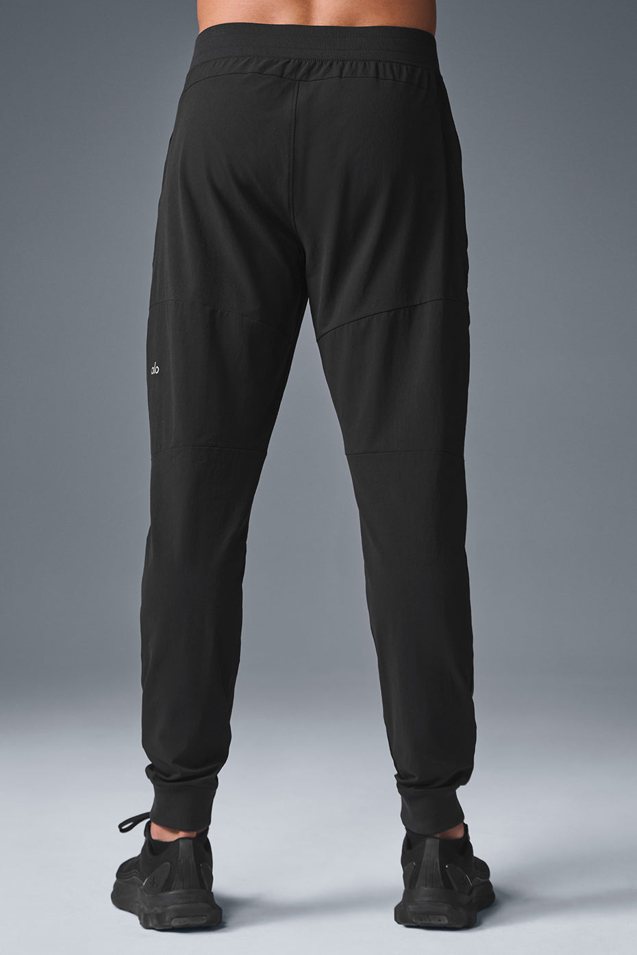 Model wearing black workout pants during a yoga session.