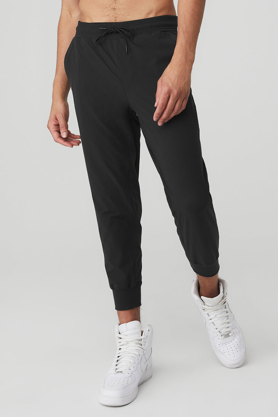 Front view of men's tech pants worn in urban setting
