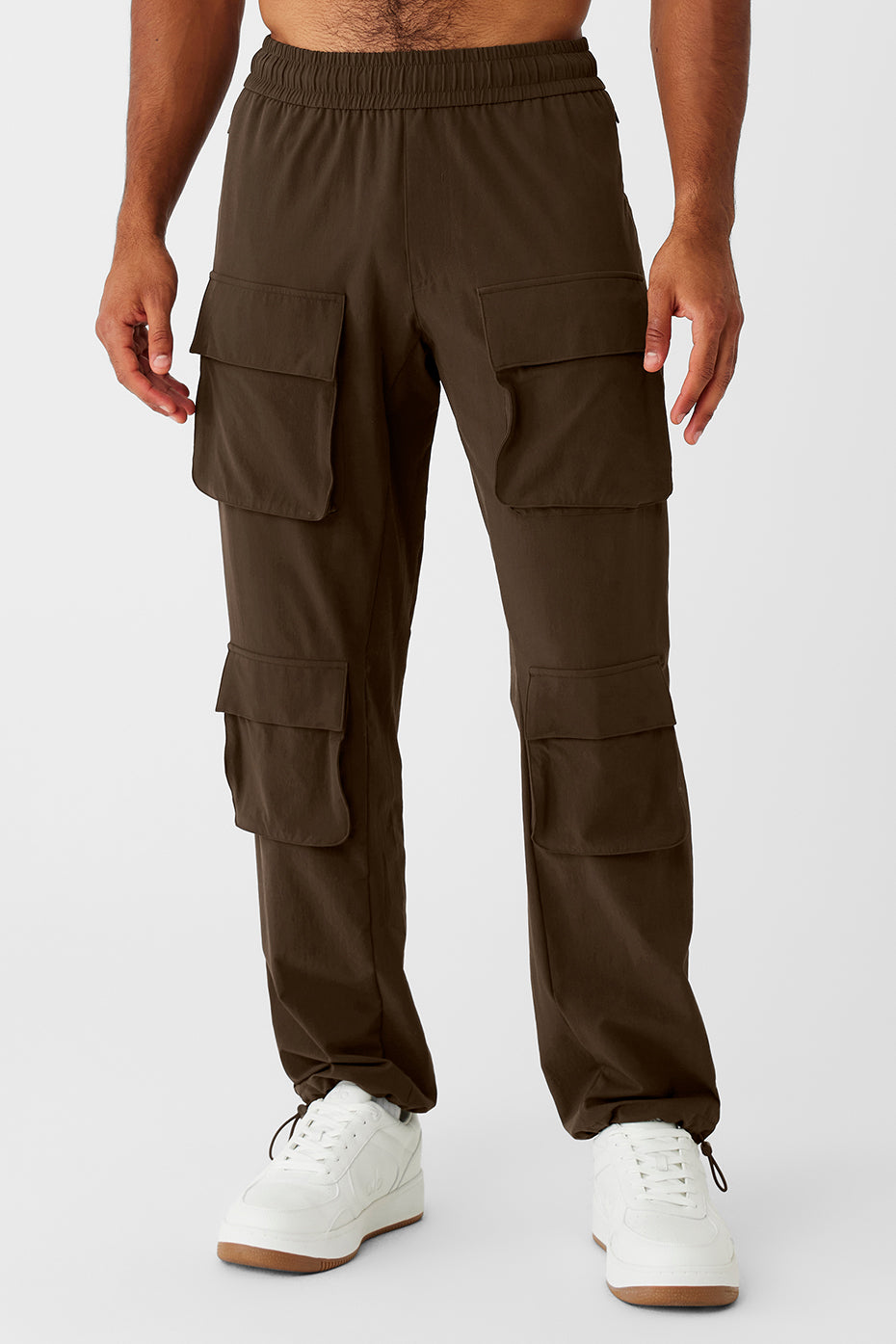 Side view of black cargo pants with cinch hem on city sidewalk