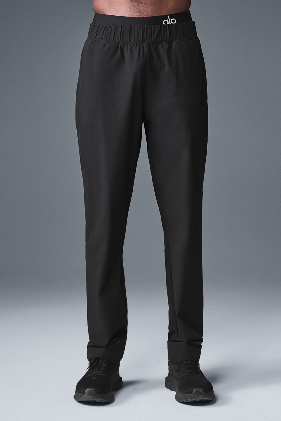 Close-up of black performance joggers featuring darting details.