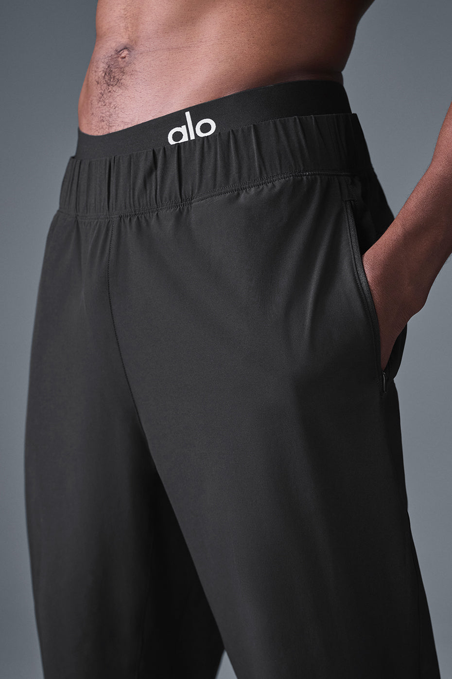 Close-up of black performance joggers featuring darting details.