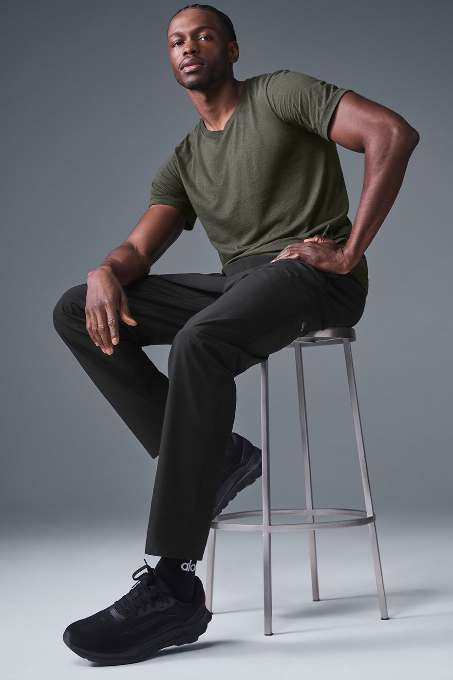 Model wearing black joggers in a studio setting, ideal for workouts.