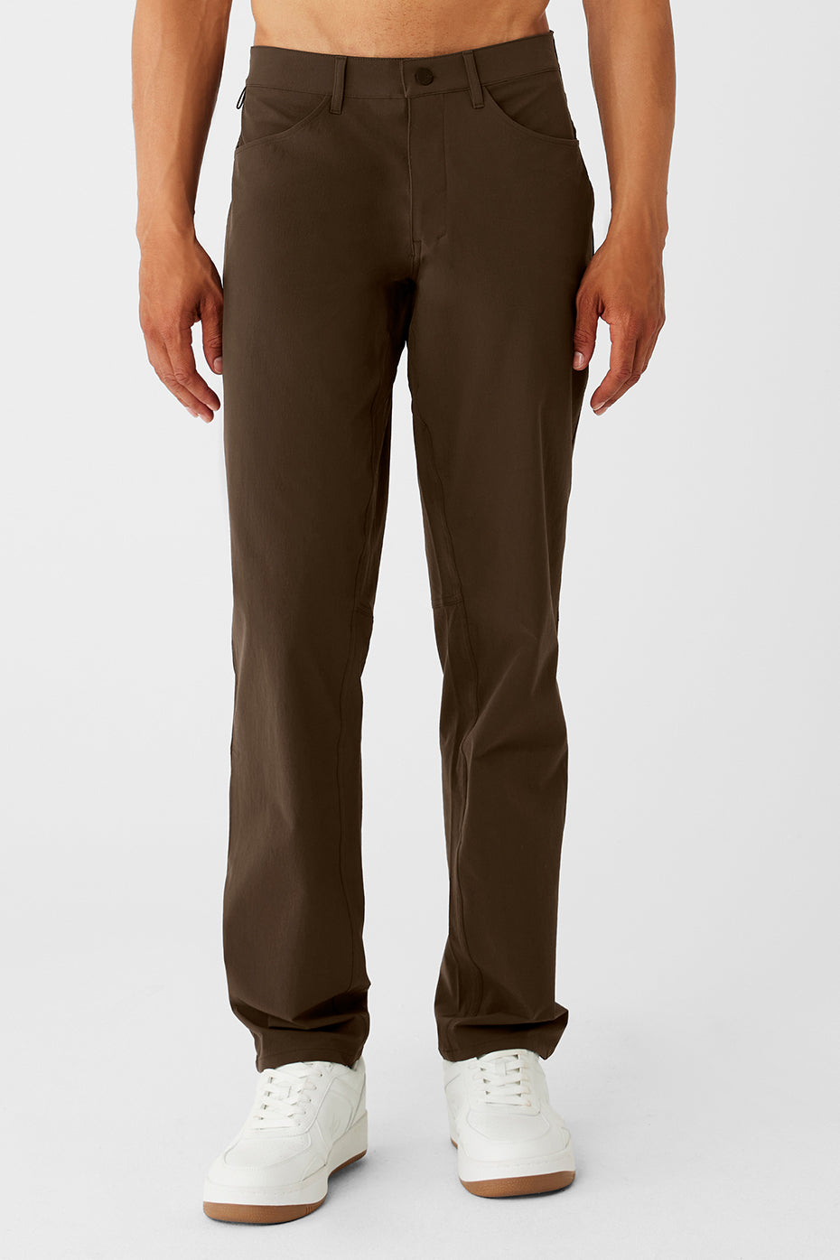 Close-up of espresso performance pants highlighting fabric texture and pocket details