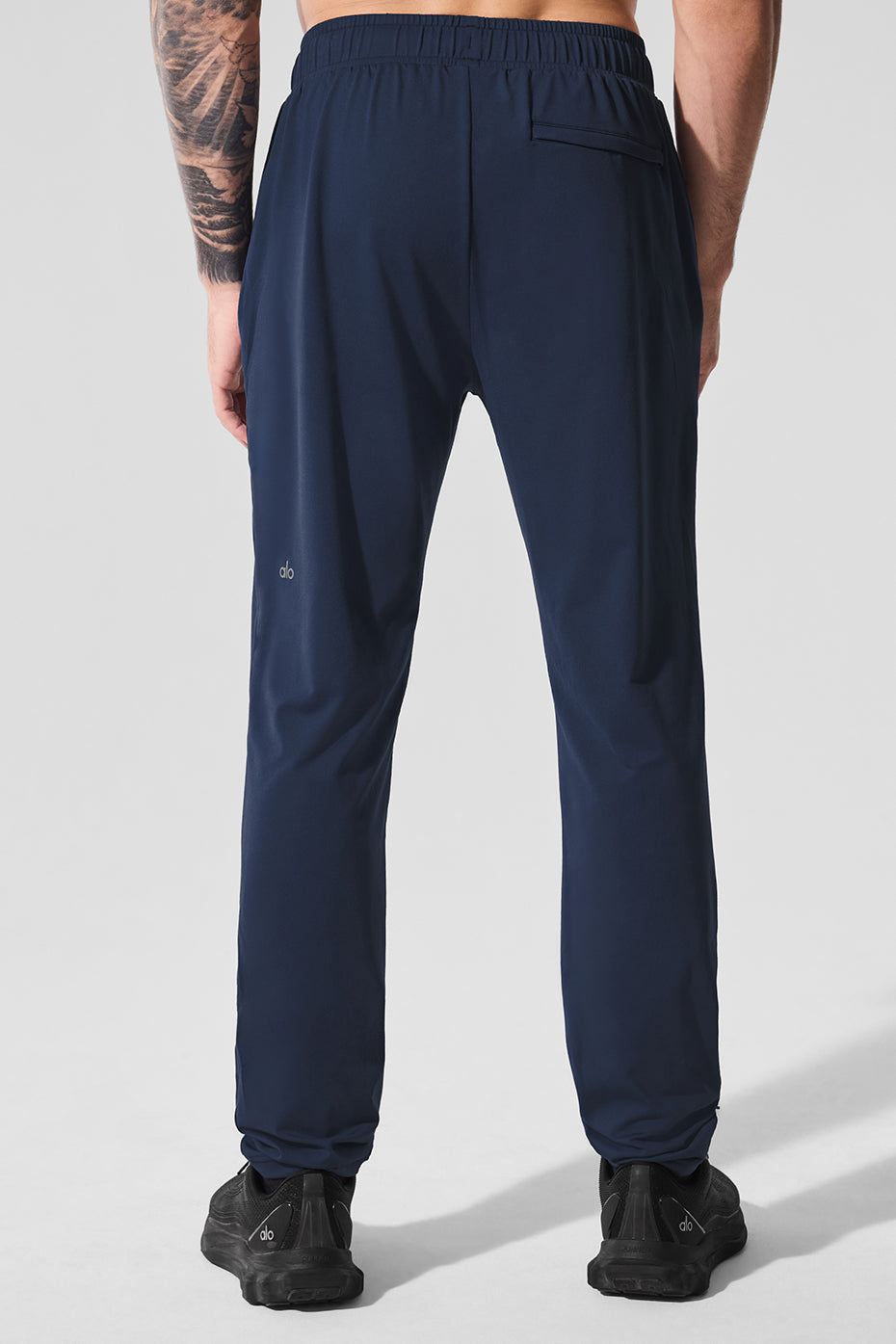 Detail shot of adjustable drawcords and faux fly on mens performance pants