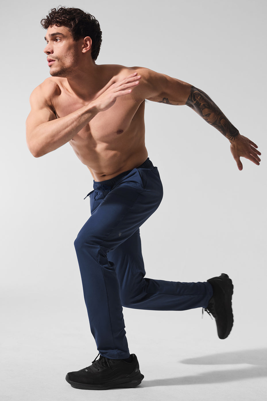 Detail shot of adjustable drawcords and faux fly on mens performance pants
