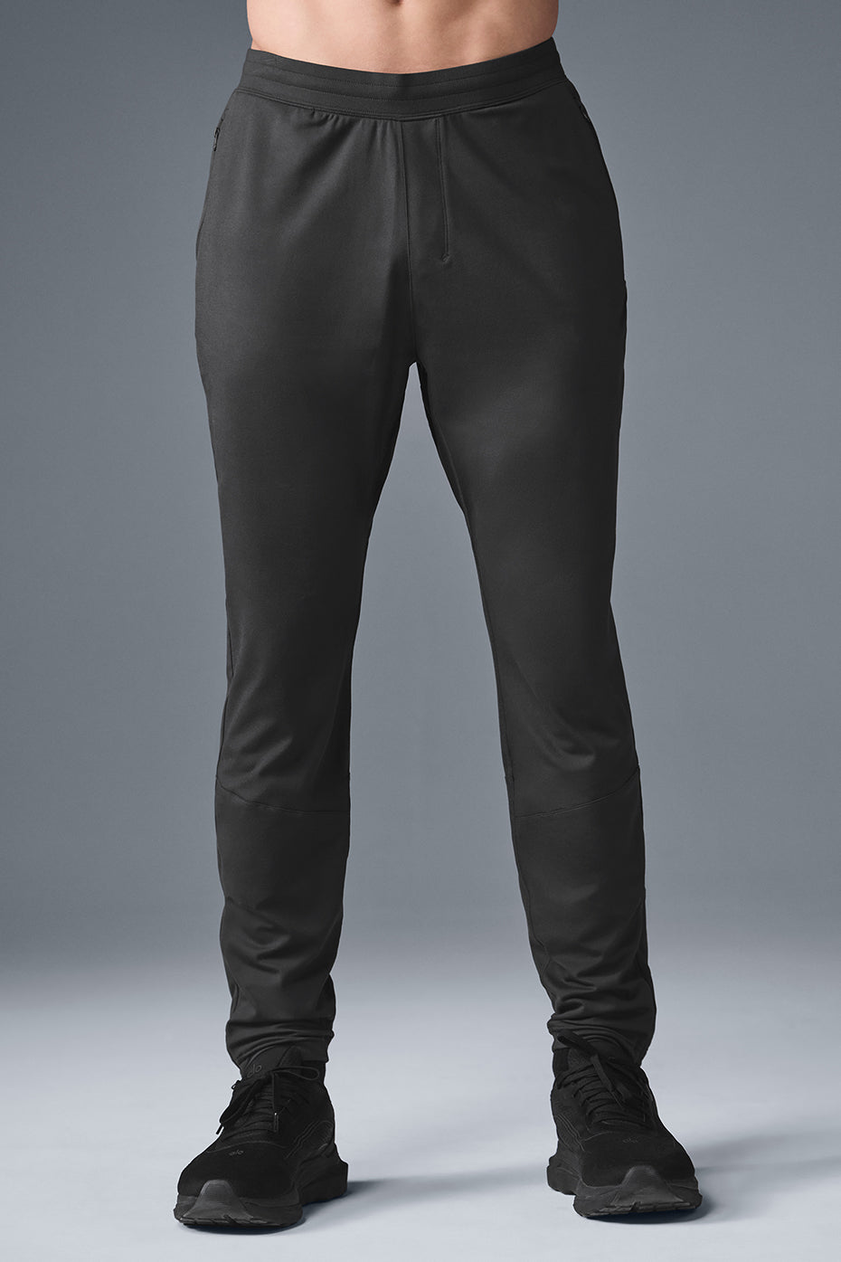 Men's performance pants in anthracite color showing breathable fabric and modern fit