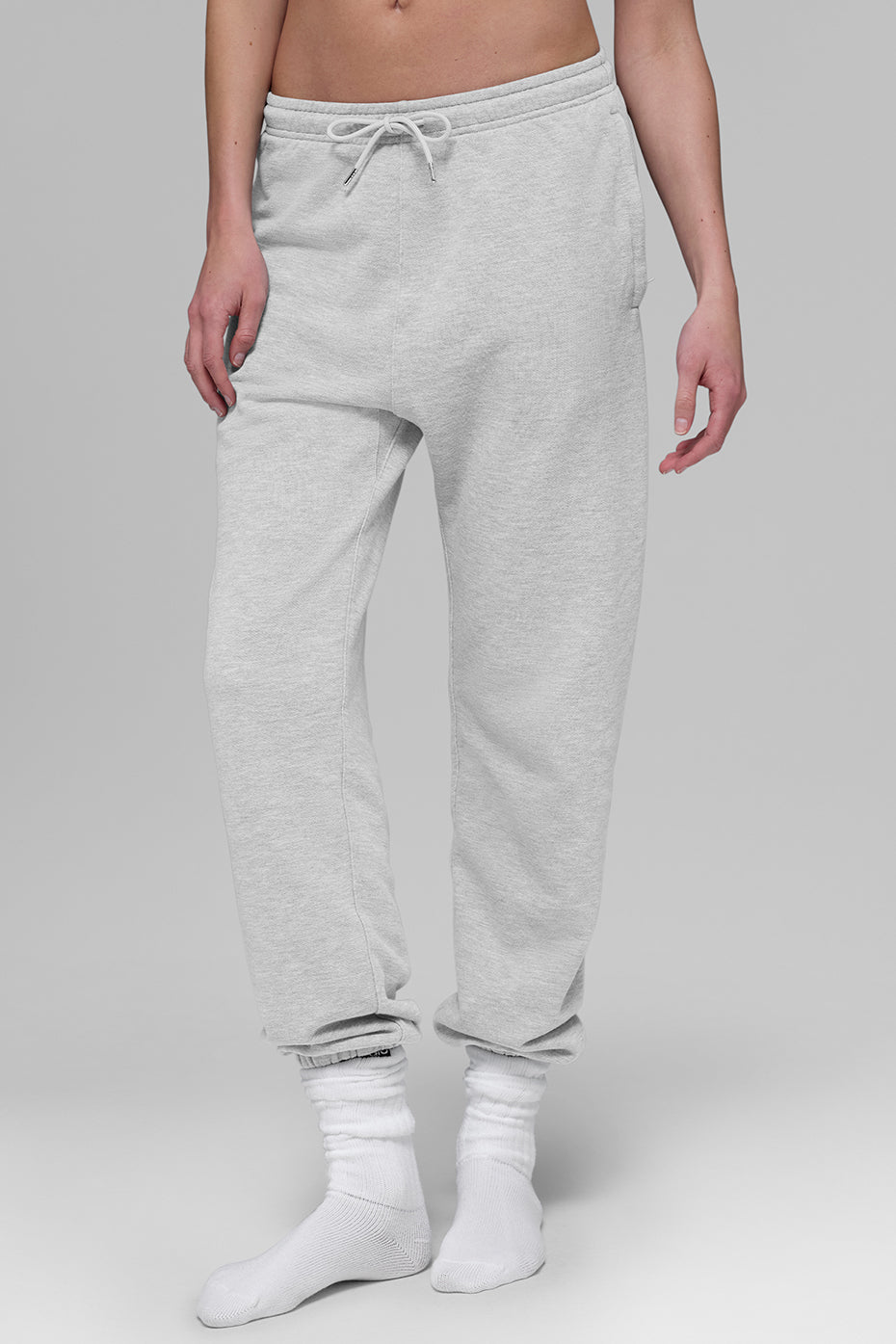 Outfit shot featuring black sweatpants styled with a hoodie