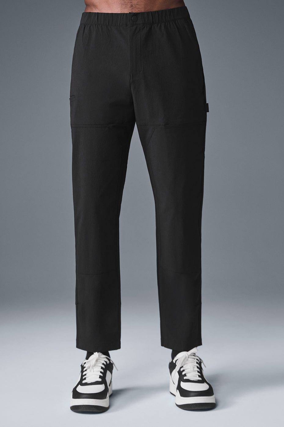 Front view of black cargo pants with hammer loop detail.
