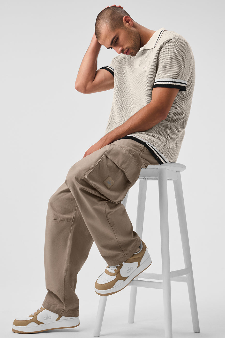Model wearing Vuori ripstop cargo pants with side pockets for outdoor adventures