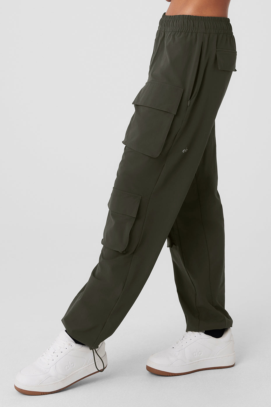 Model wearing black cargo pants variant while hiking forest trails