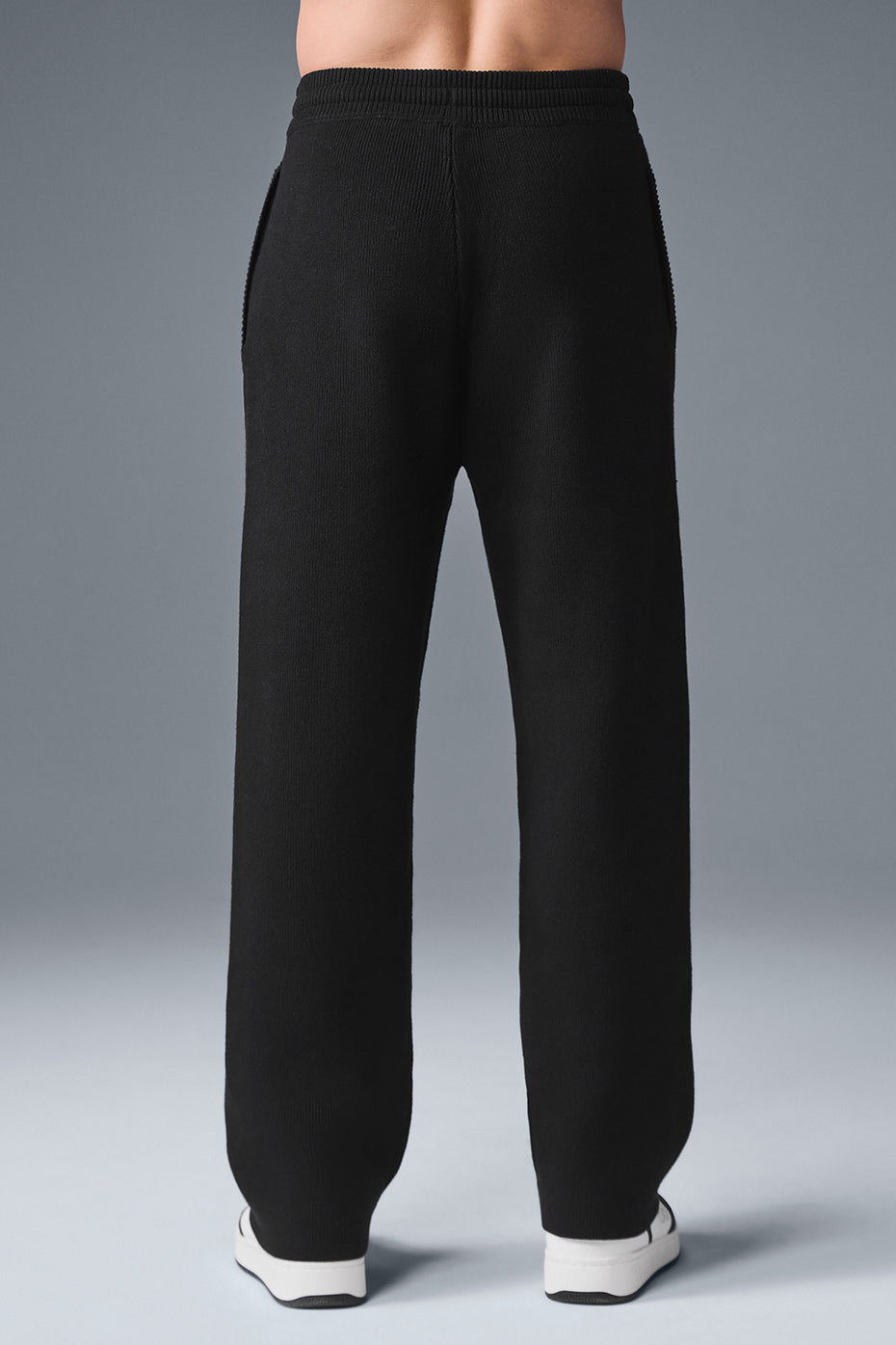 Model demonstrating the fit of the camo sweatpants in an urban setting.