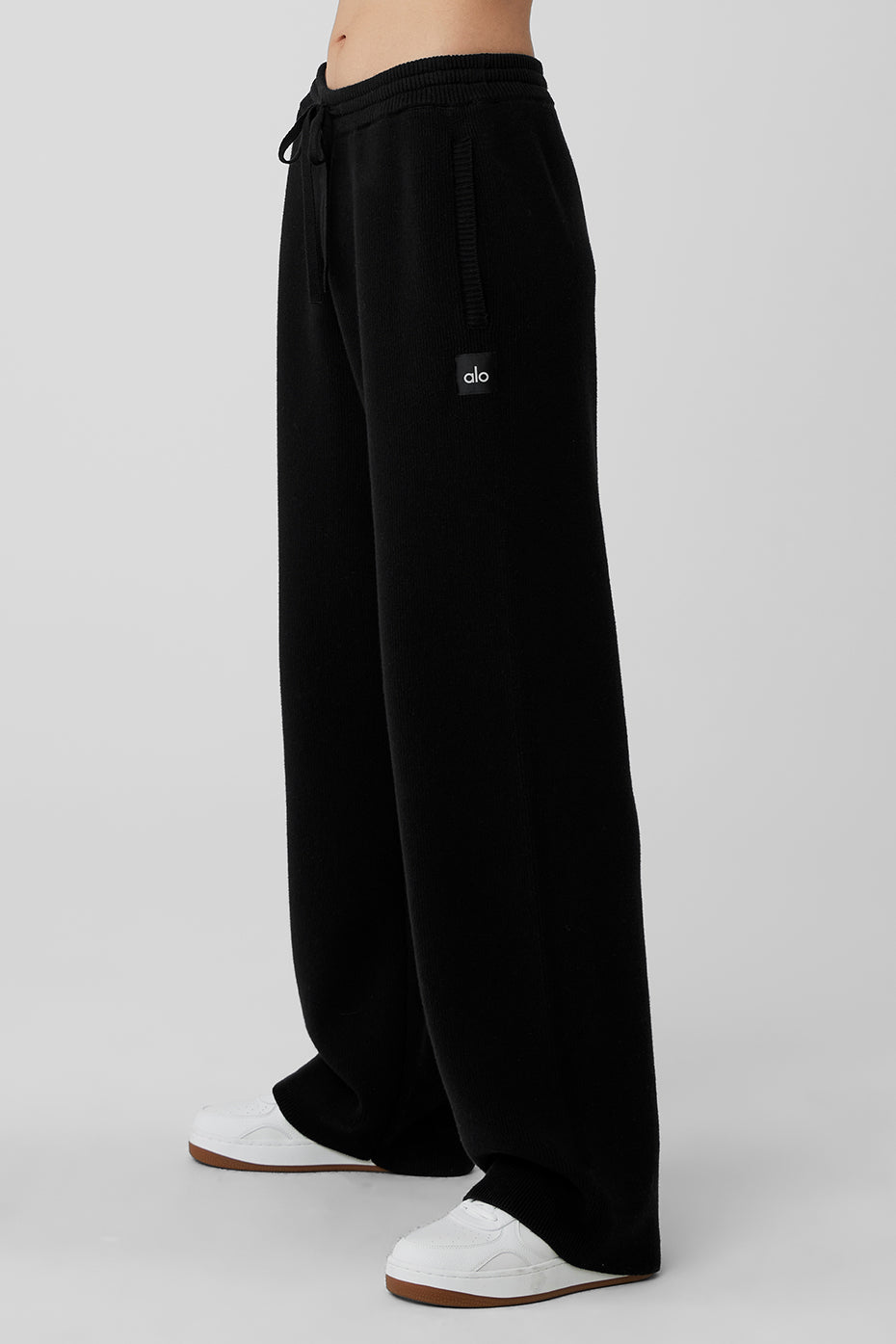 Model wearing black wide leg sweatpants paired with a long sleeve top.