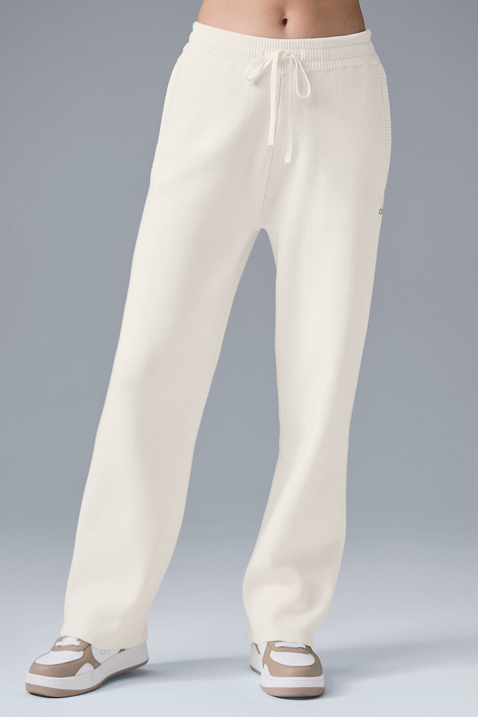 Model wearing ivory wide leg sweatpants with relaxed baggy fit